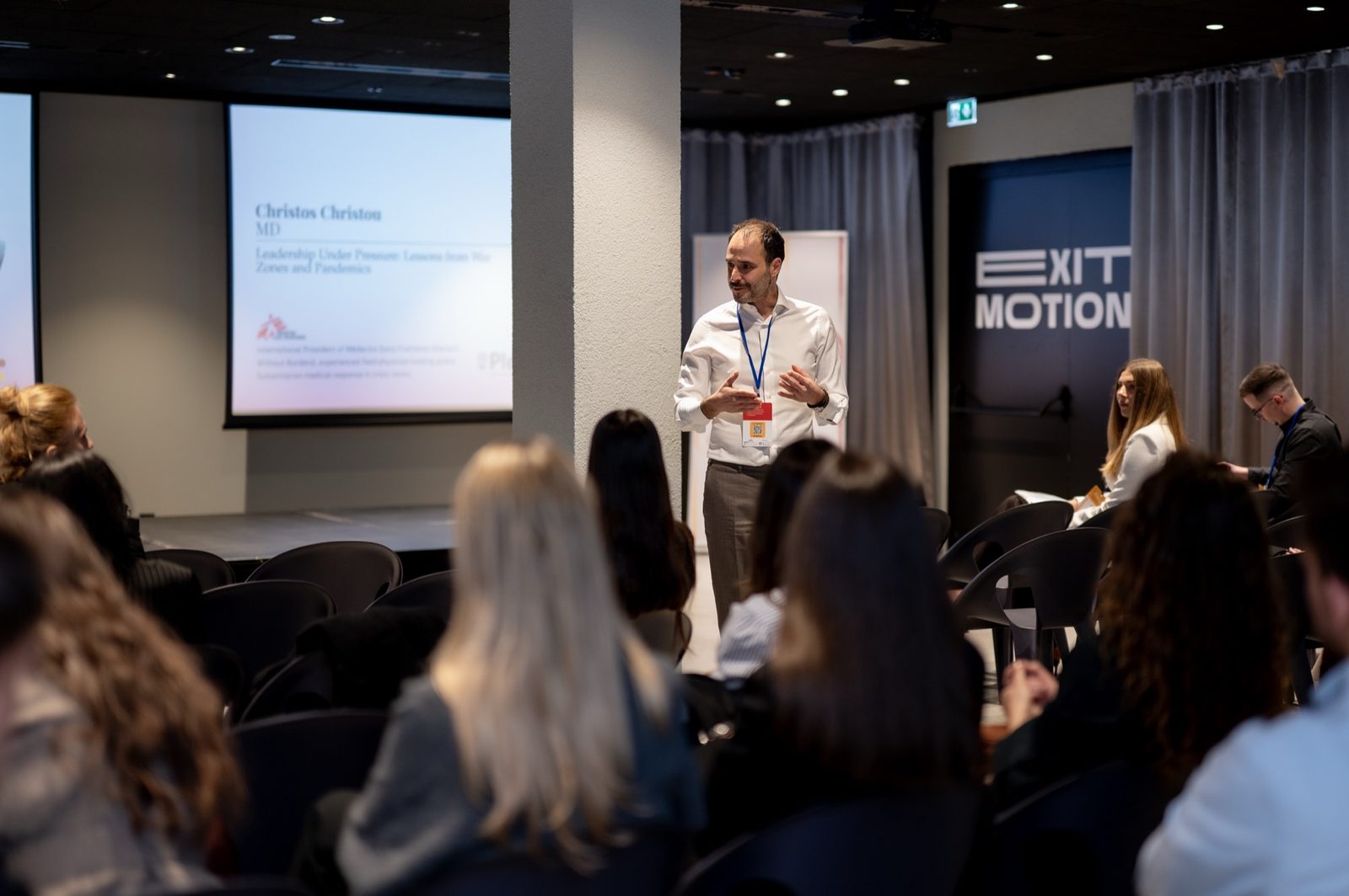 A Plexus speaker in conversation among attendees between talks